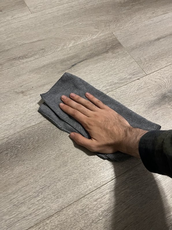 Hand Wiping Wood with a Cloth